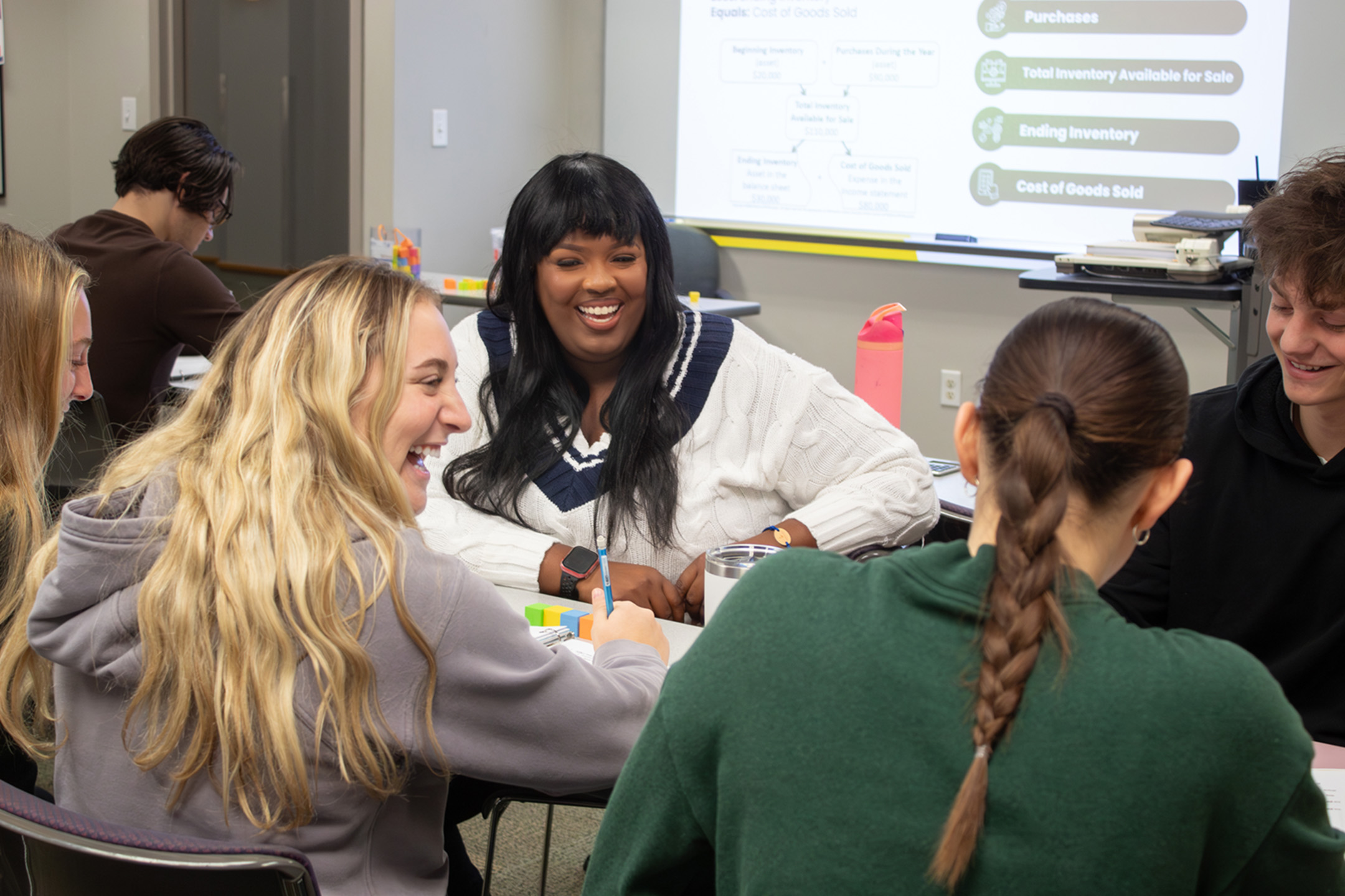 Brittani Shantel Jackson seated at a table interacting with students
