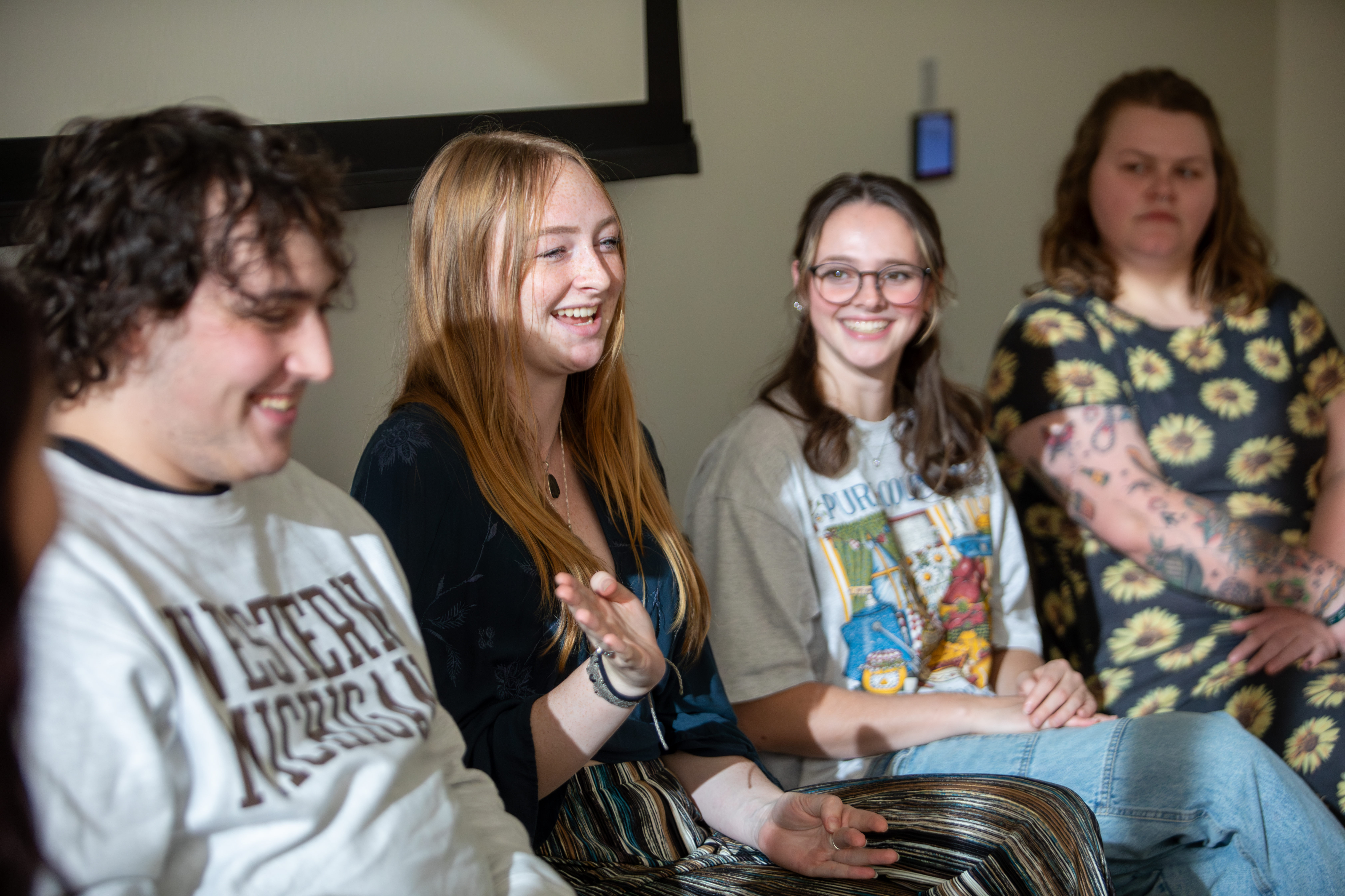 Students laugh while talking about their study abroad journeys during an International Education Week event.