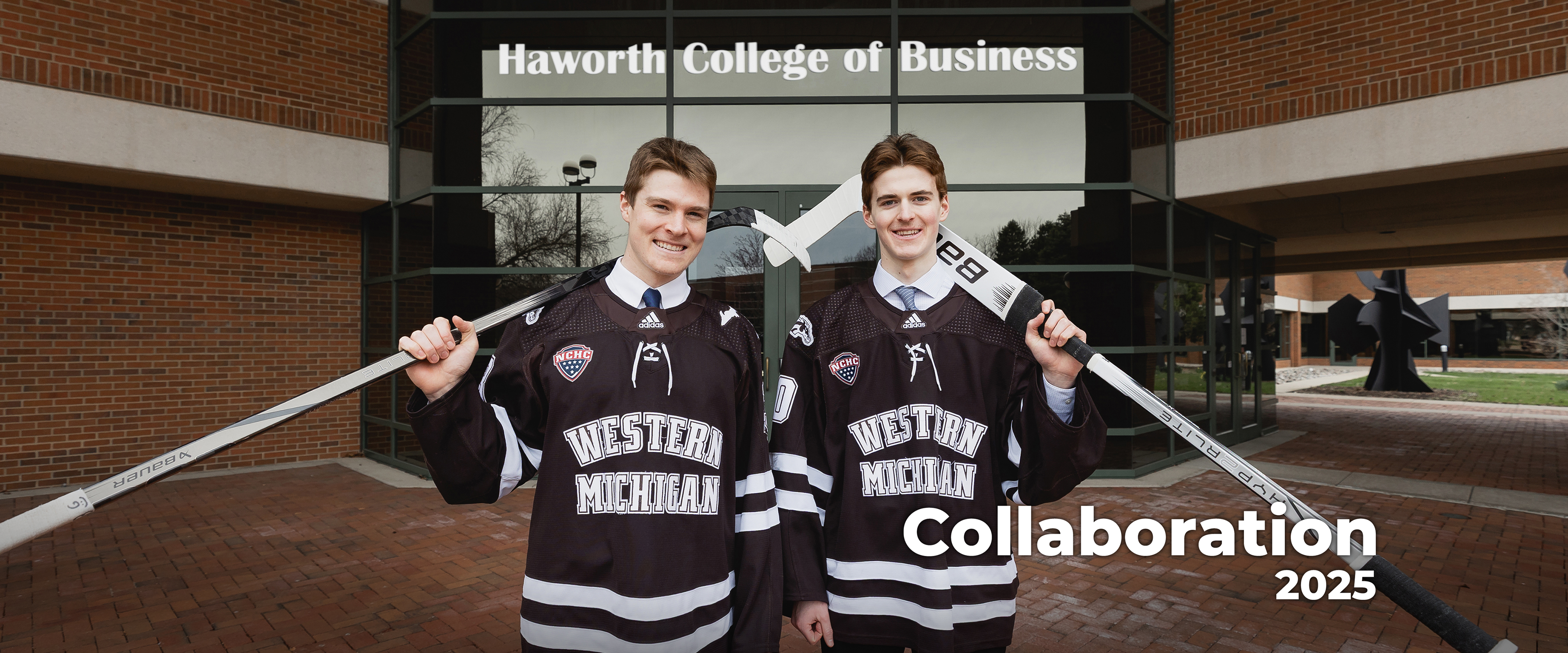 Two Students from the WMU Hockey Team standing in front of the WMU Haworth Building