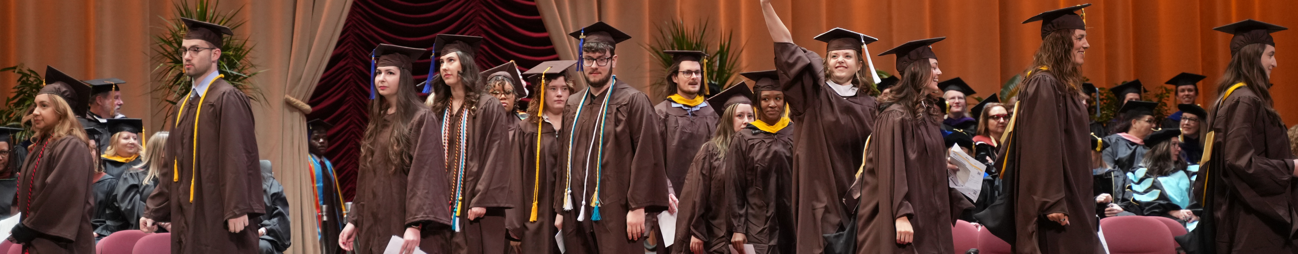group of graduates on stage at Miller Auditorium