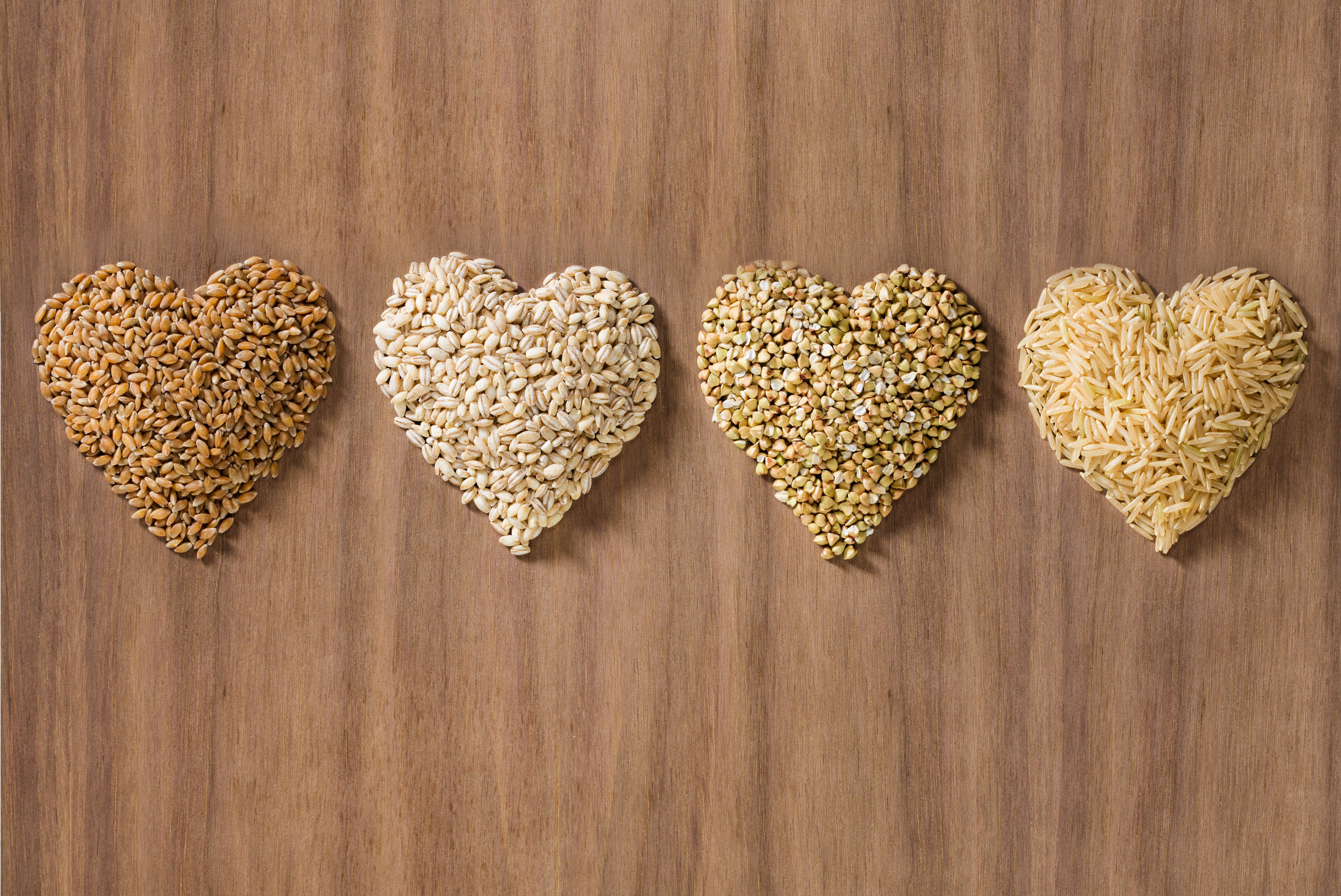 Grains formed in the shape of hearts on a wood background
