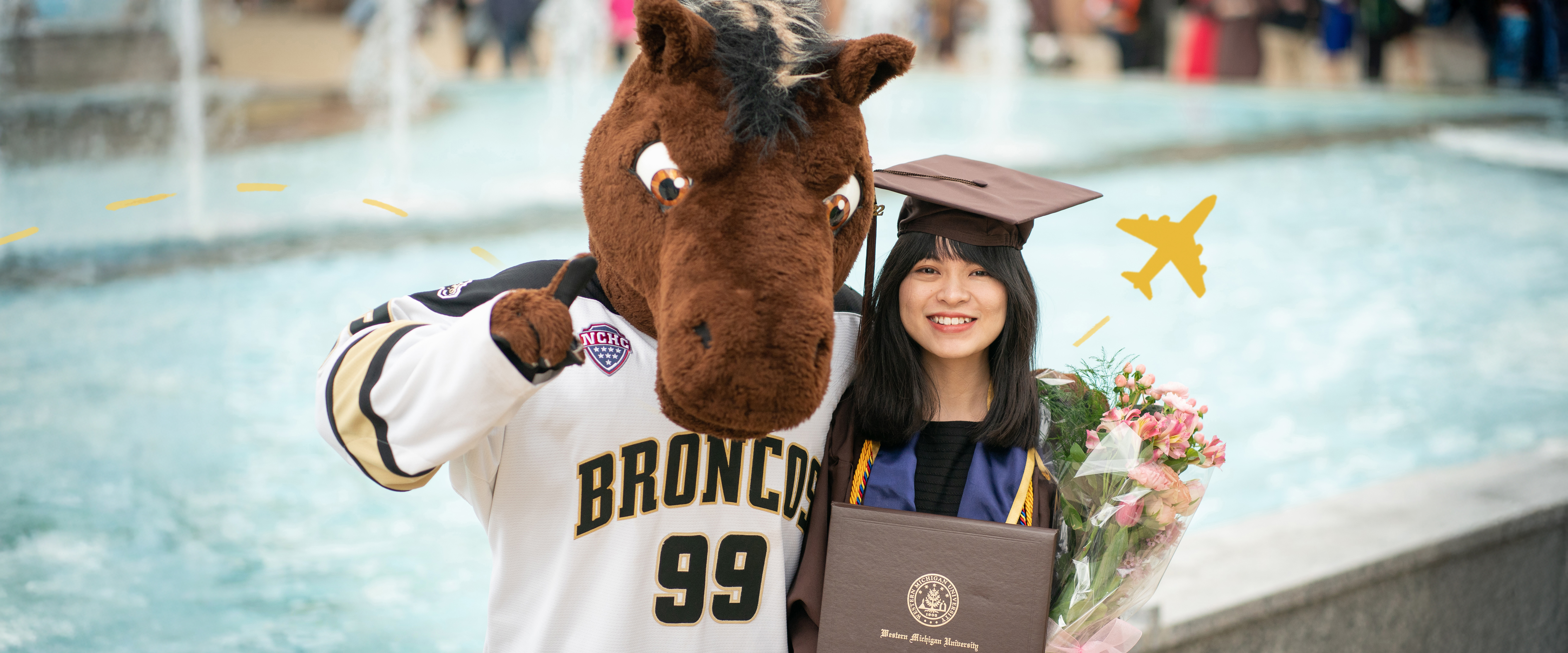 A girl student graduating with Buster Bronco