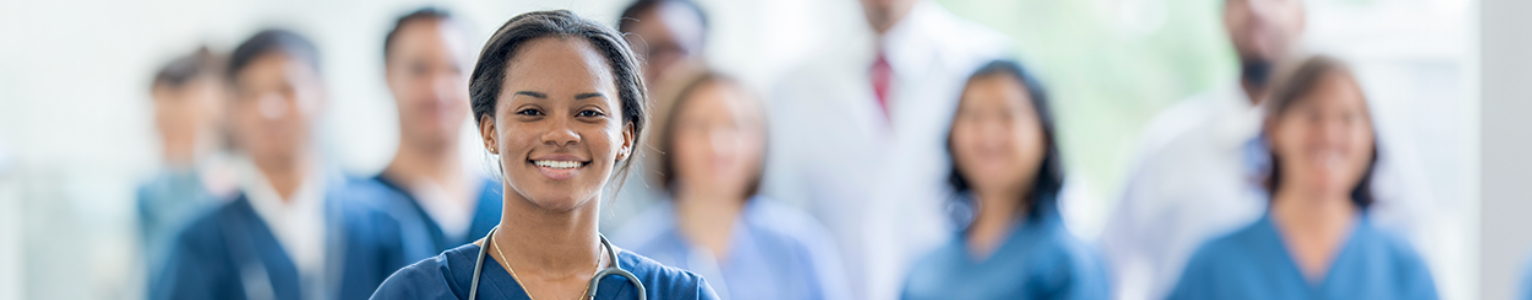 image of feamle nurse in focus with other nurses blurred.