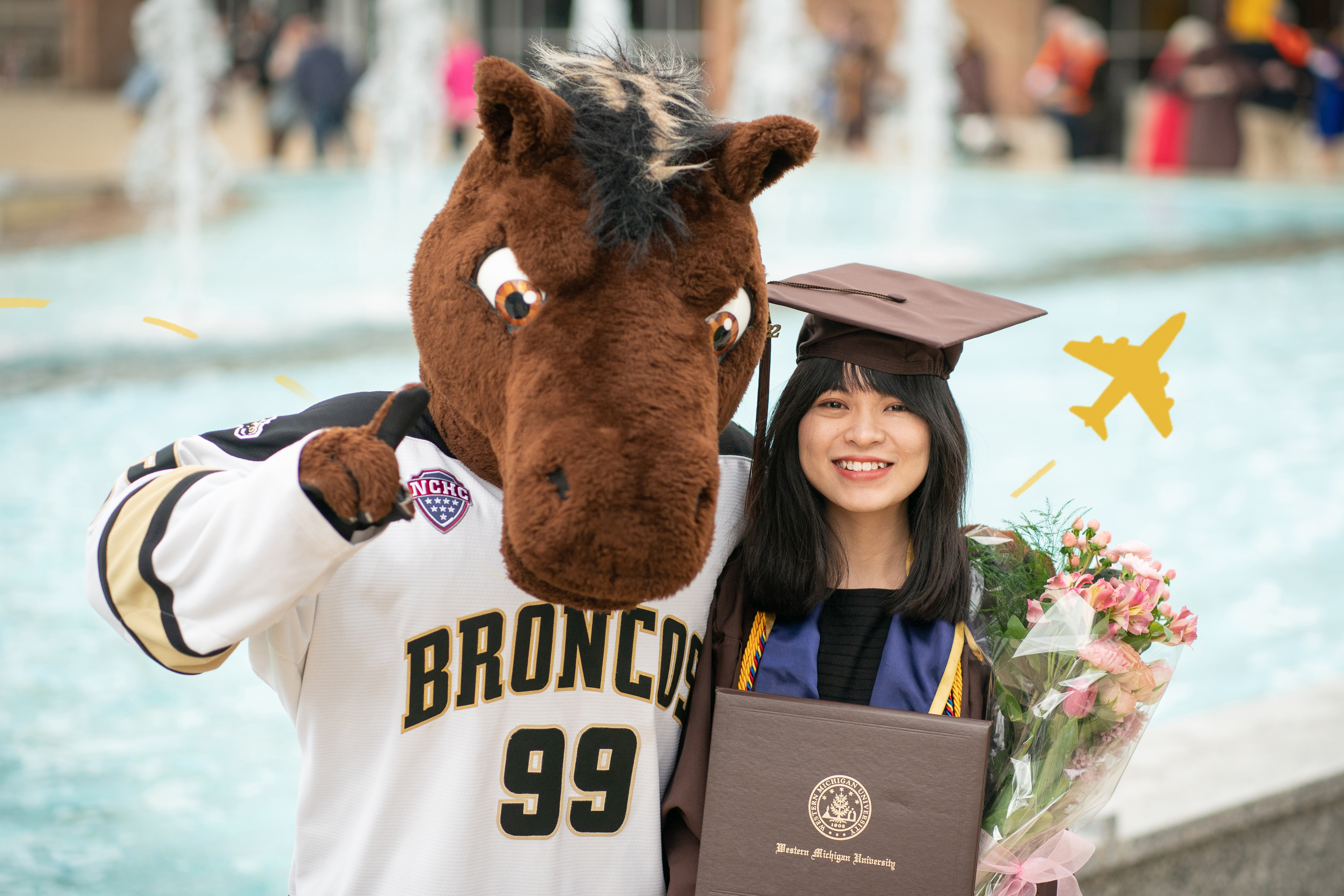 A girl student graduating with Buster Bronco