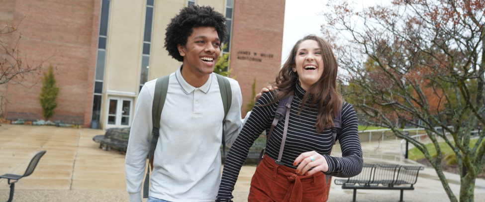 Students walking and laughing on campus