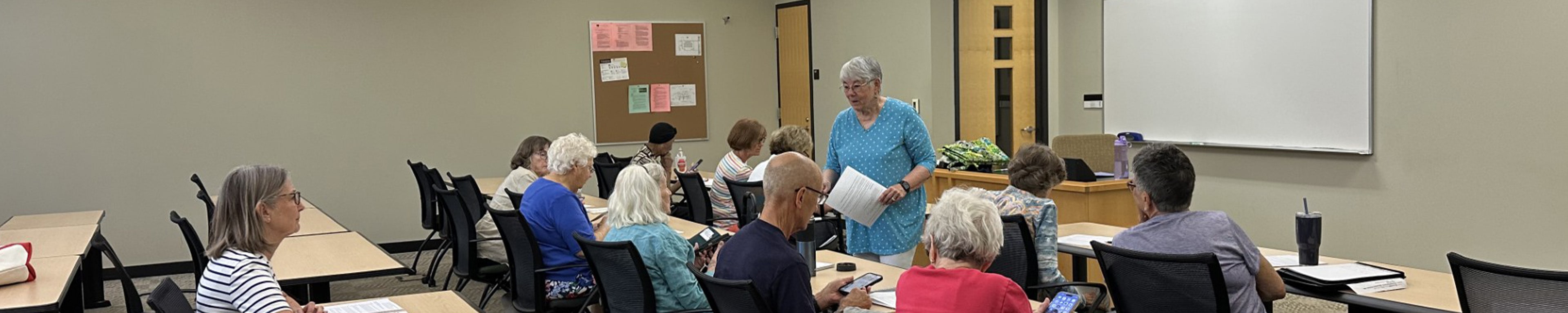 A member of OLLI teaching a course on proper use of an IPhone in WMU'x OLLI program