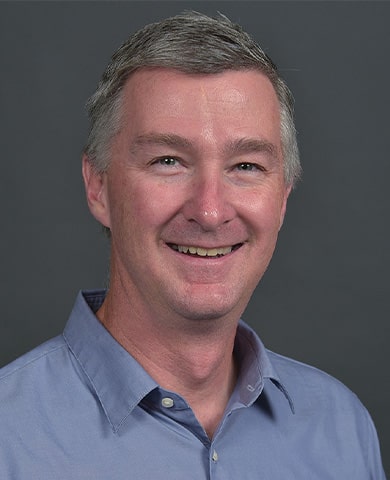 A slightly wider professional headshot of Jim Eckert