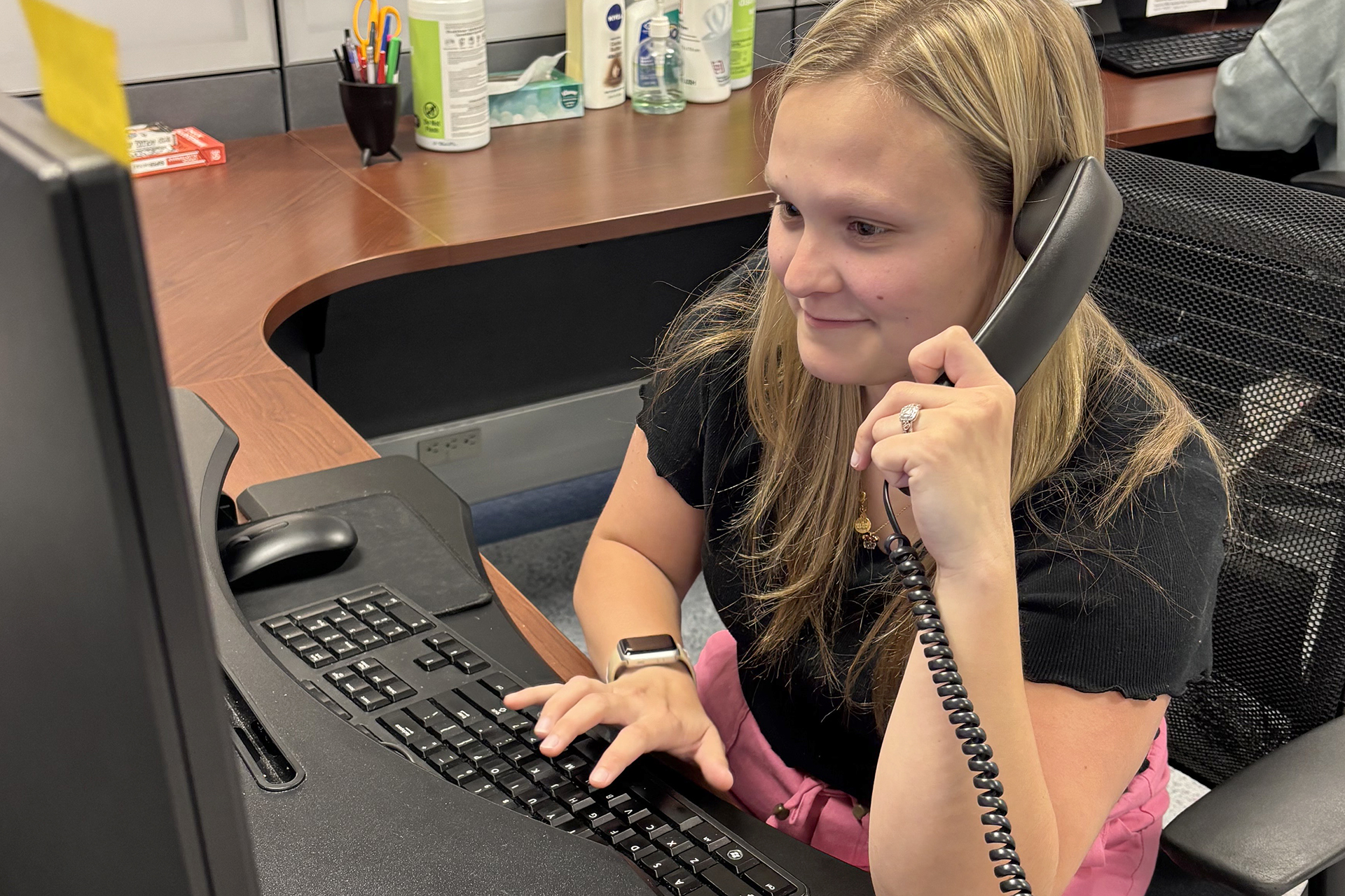 Ellie Lundy working at the IT Front Desk, as a swtichboard operator, in the University Computing Center
