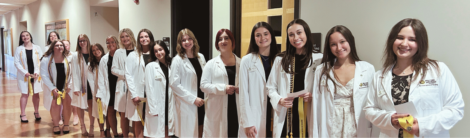 A photo of nursing students lined up for a pinning ceremony