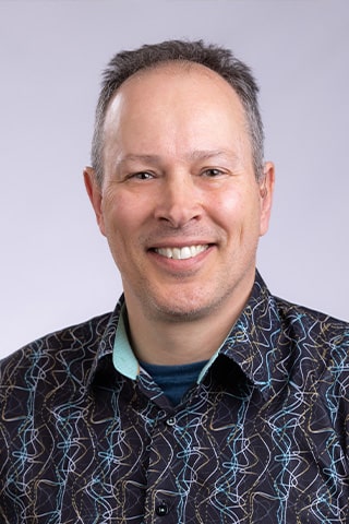 A professional headshot of Edward Eckel.
