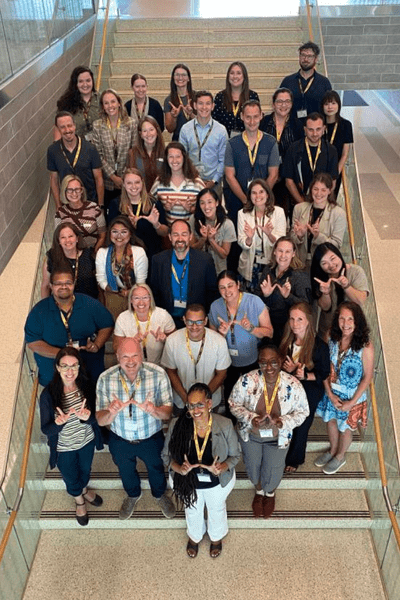 Attendees of the 2025 new faculty orientation lined up on the center stairs of Sangren