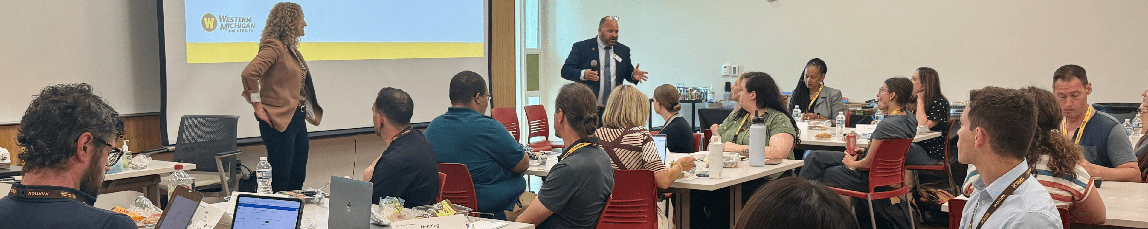 AVP Sara Nelson and Interim Provost Chris Cheatham addressing a group of new faculty at orientation