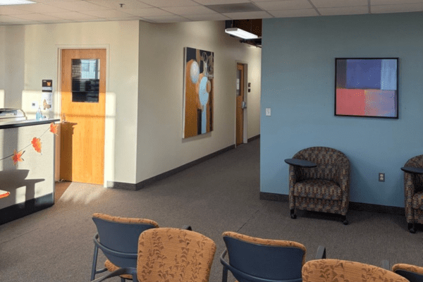 lobby area of the WMU-Grand Rapids counseling clinic, showing a check-in desk, chairs for waiting and a long hallway of counseling rooms
