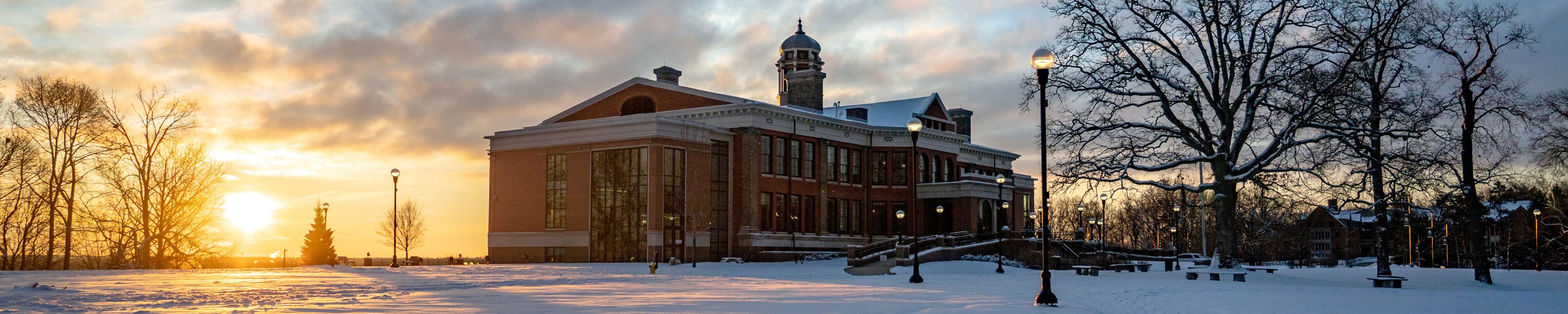 WMU Heritage Hall with snow and a sunset background