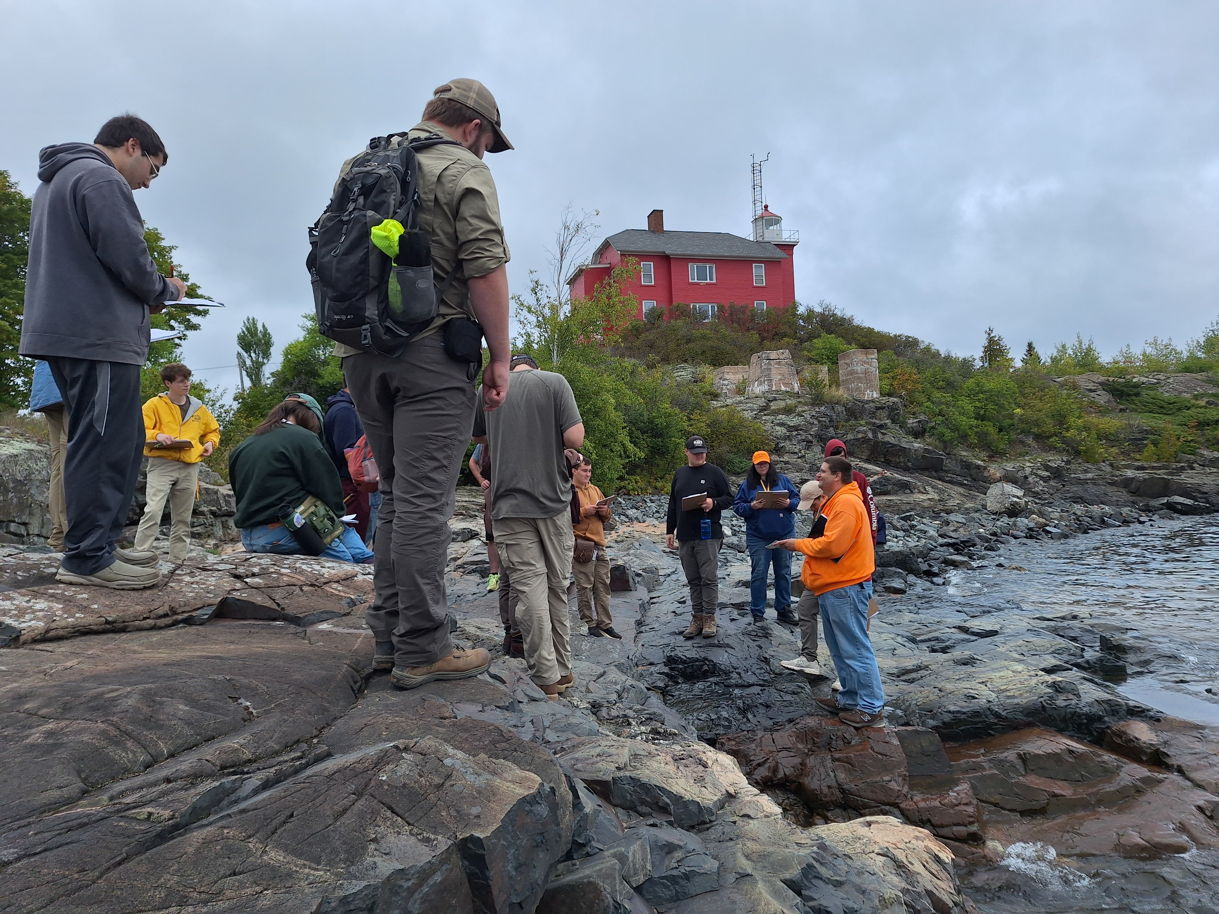 Examining rock outcrops on the shore of Lake Superior