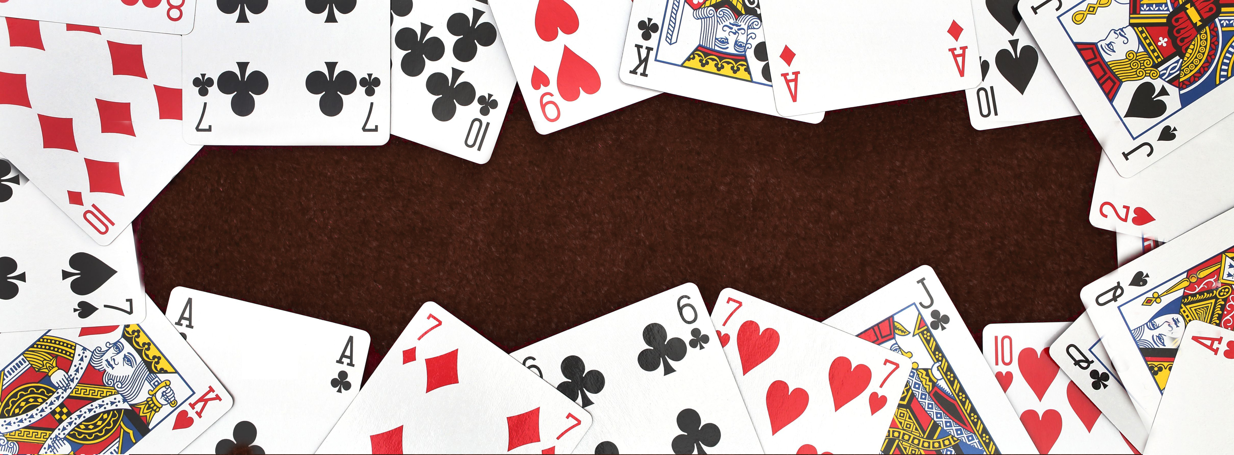 Deck of cards fanned out on the WMU background color.