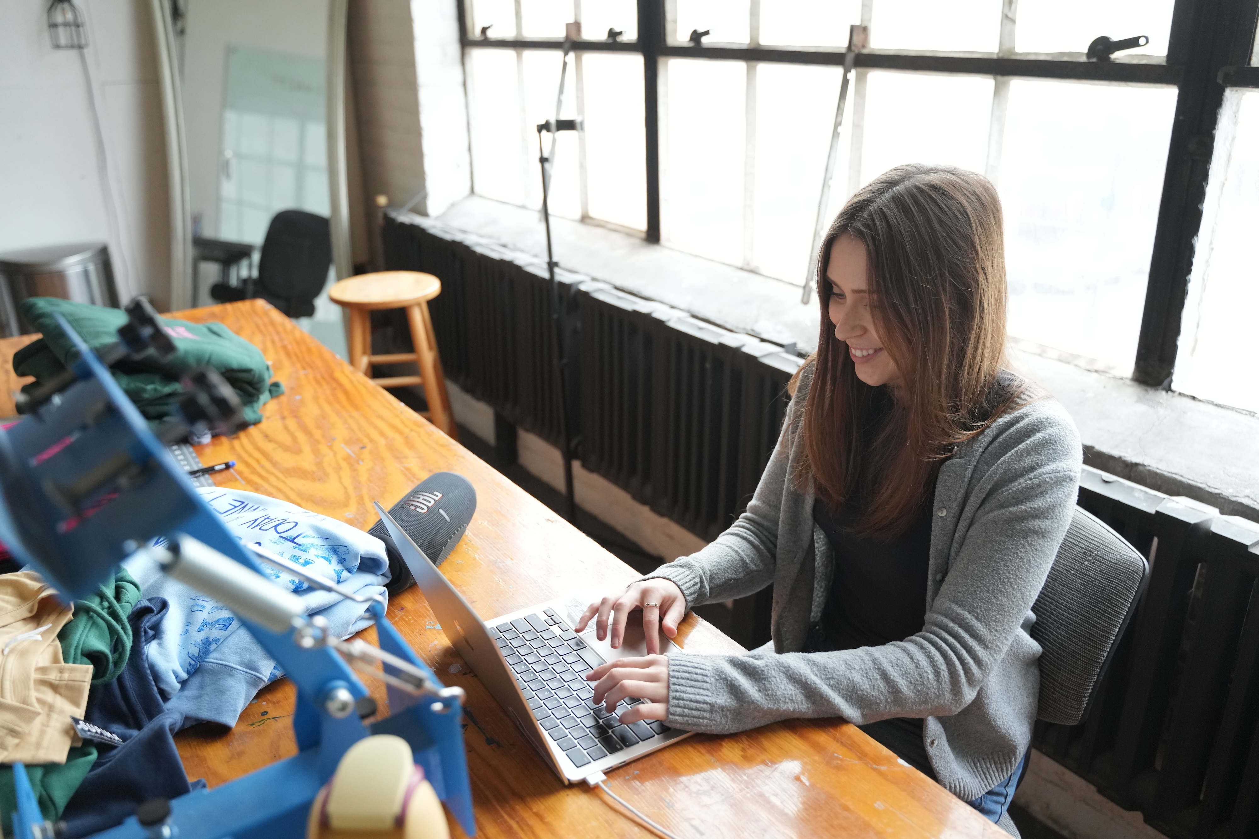 Julia Adams edits a social media post on her computer at Plannett Gunnett.