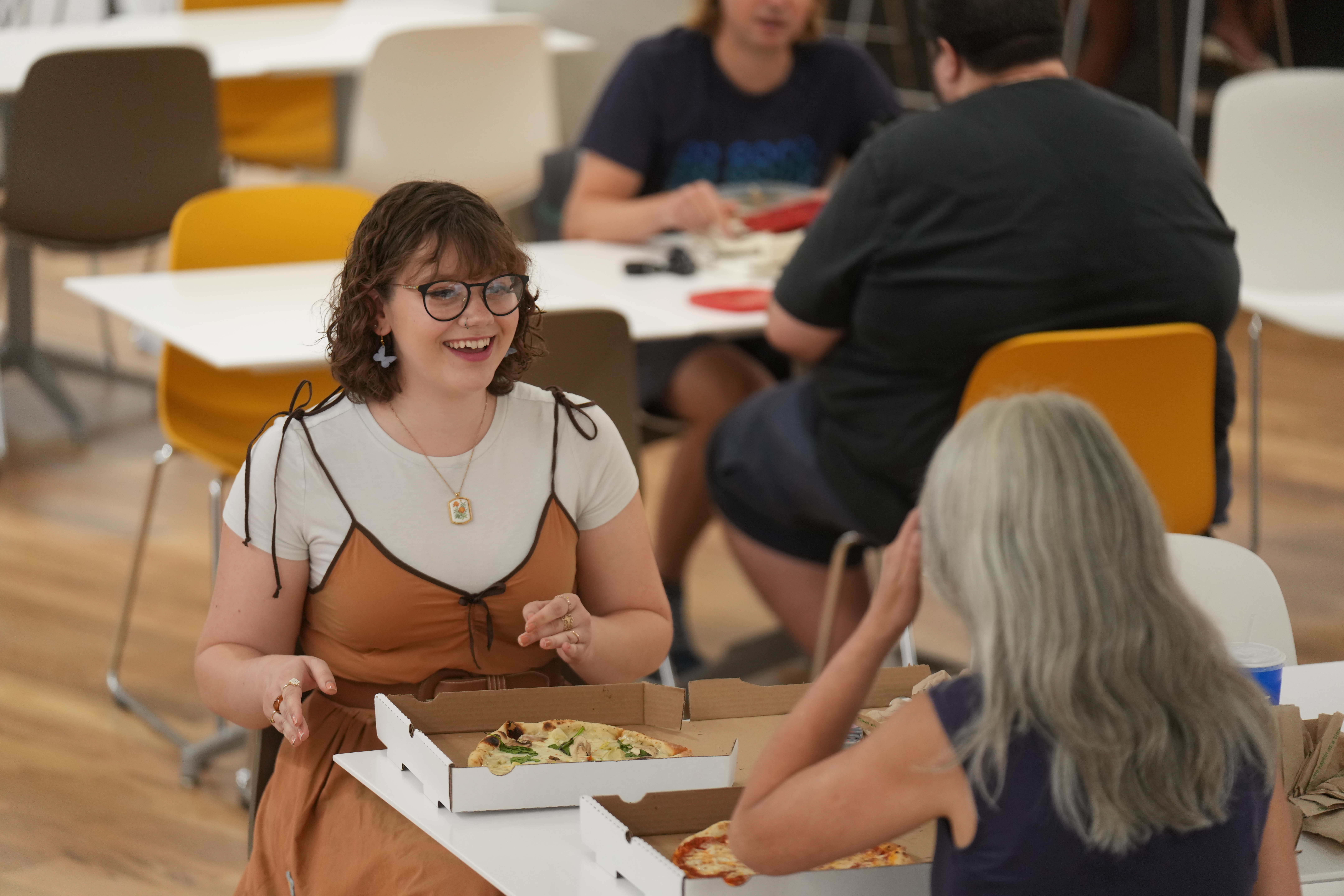 A student eating a My Pie pizza in the Student Center.