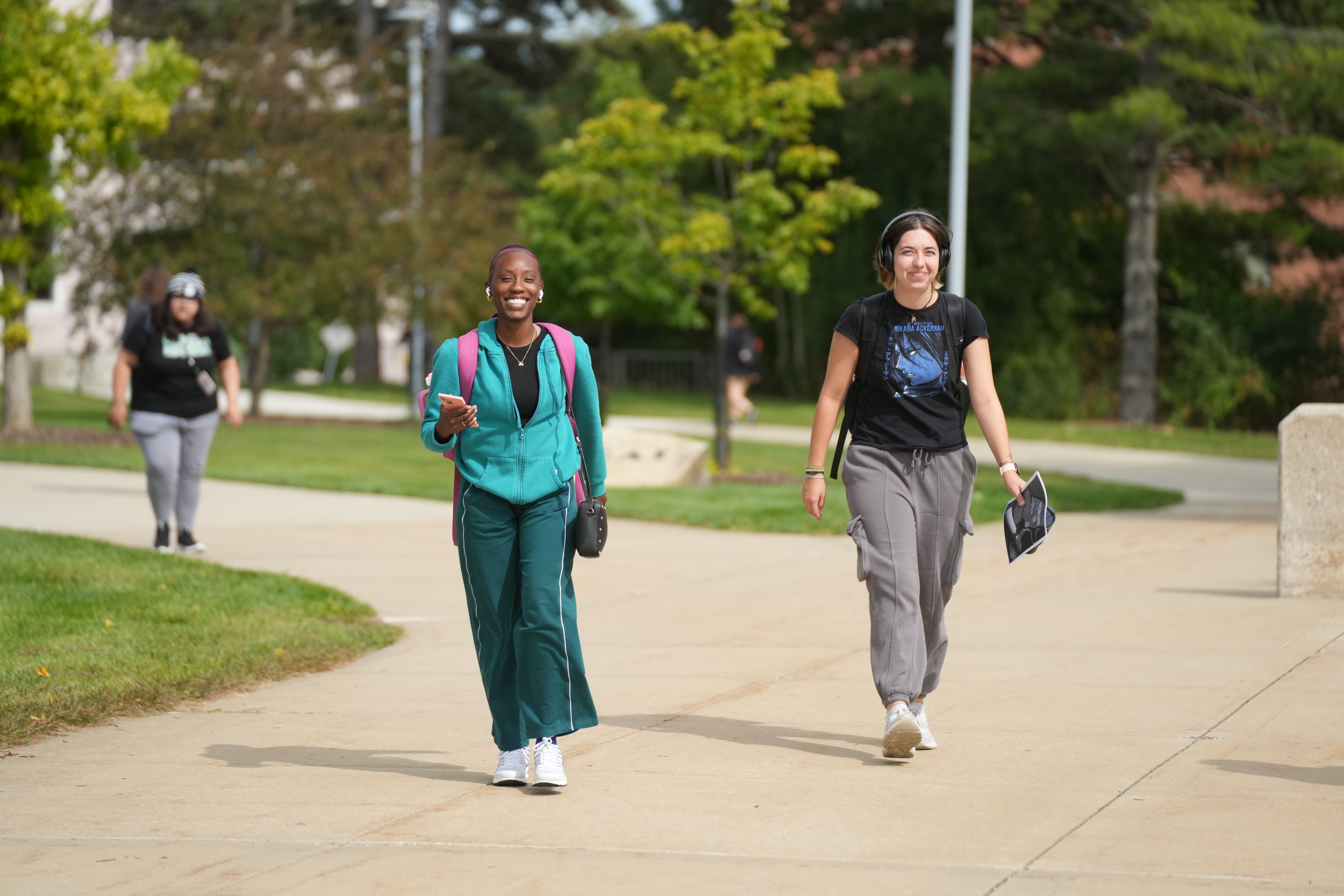 Two students walk through campus.
