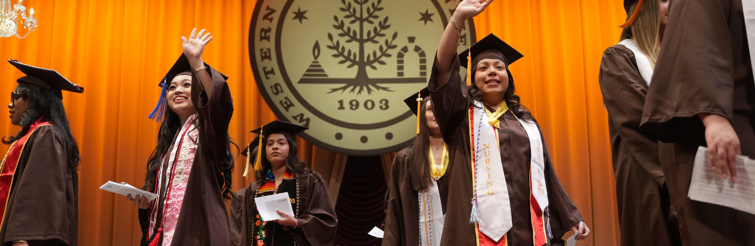 group of graduates on stage at Miller Auditorium