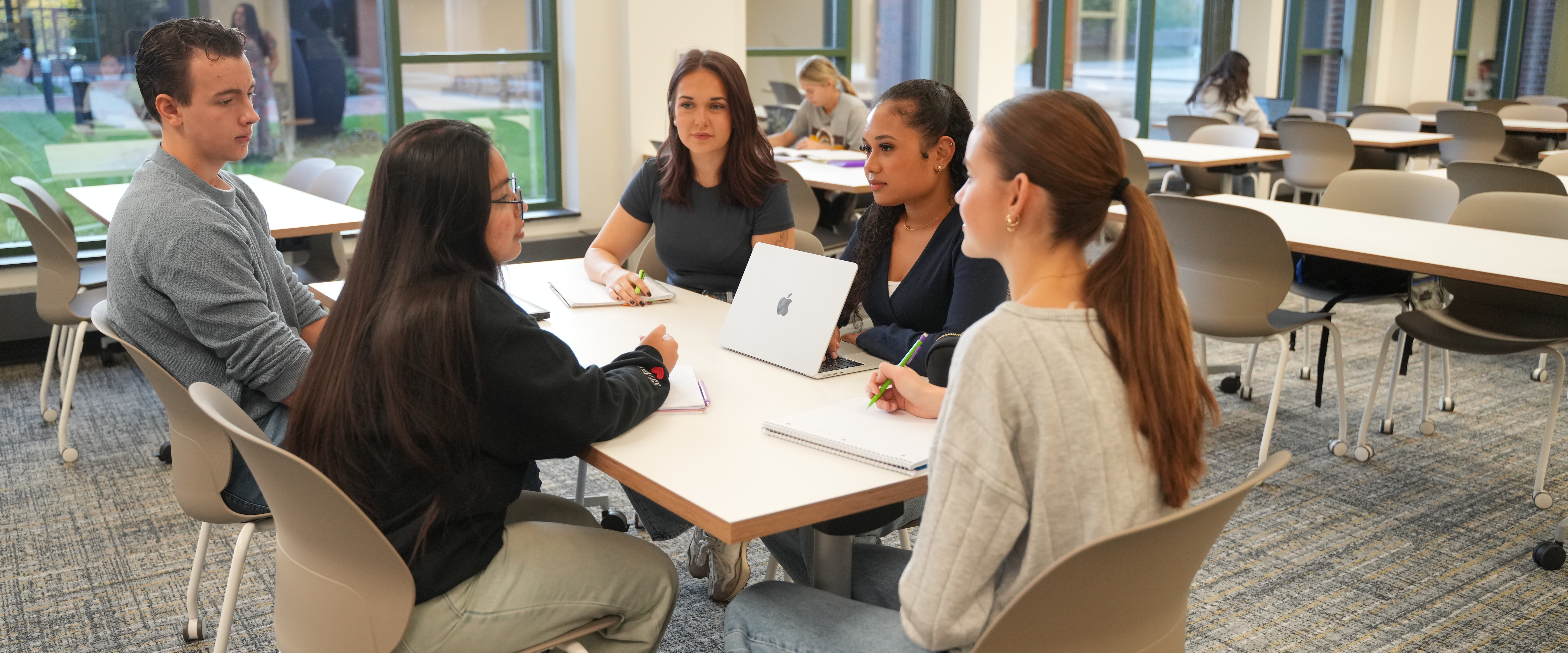 Students working at a table in the study lounge