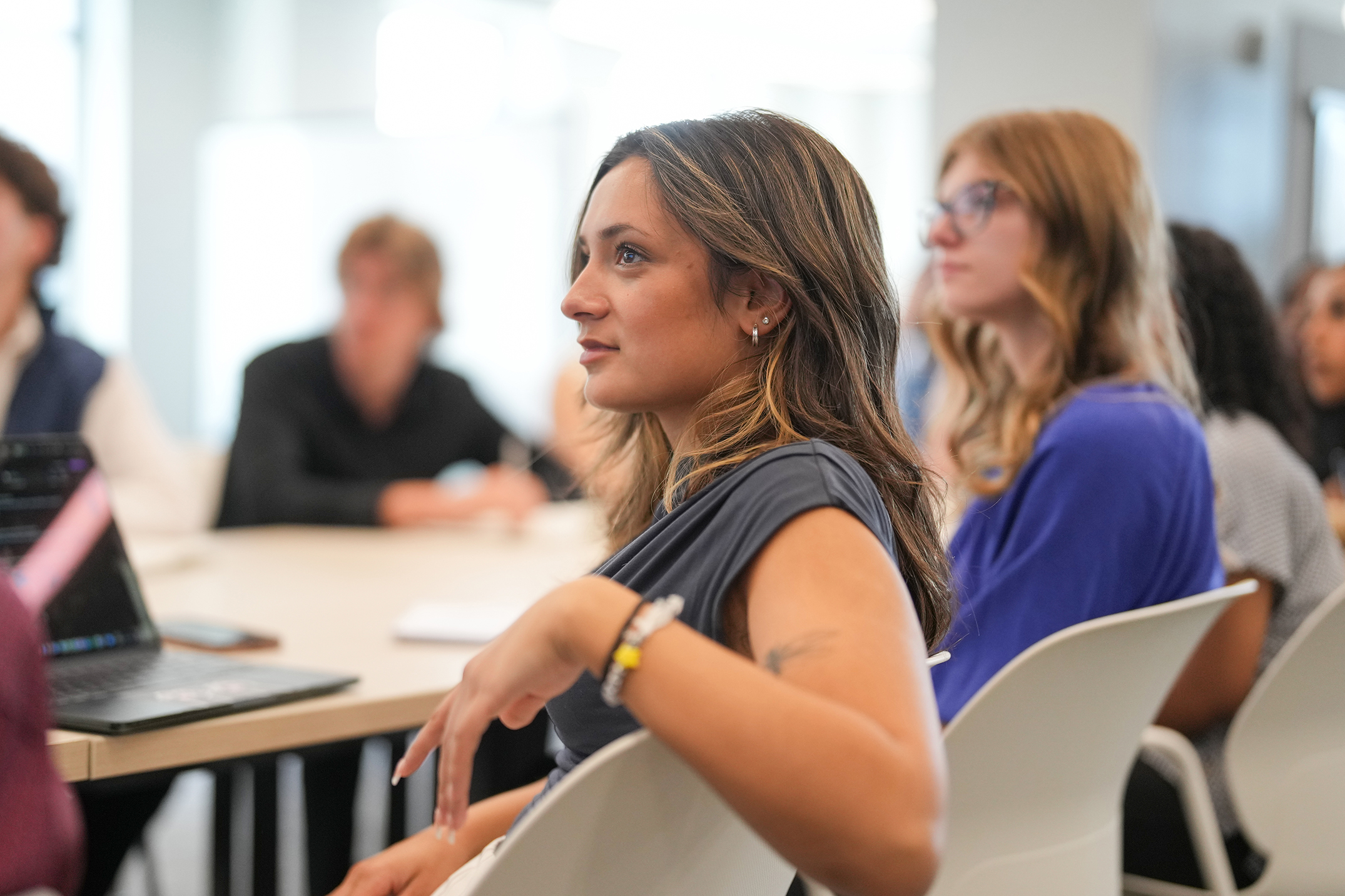 A woman sitting during a listening session