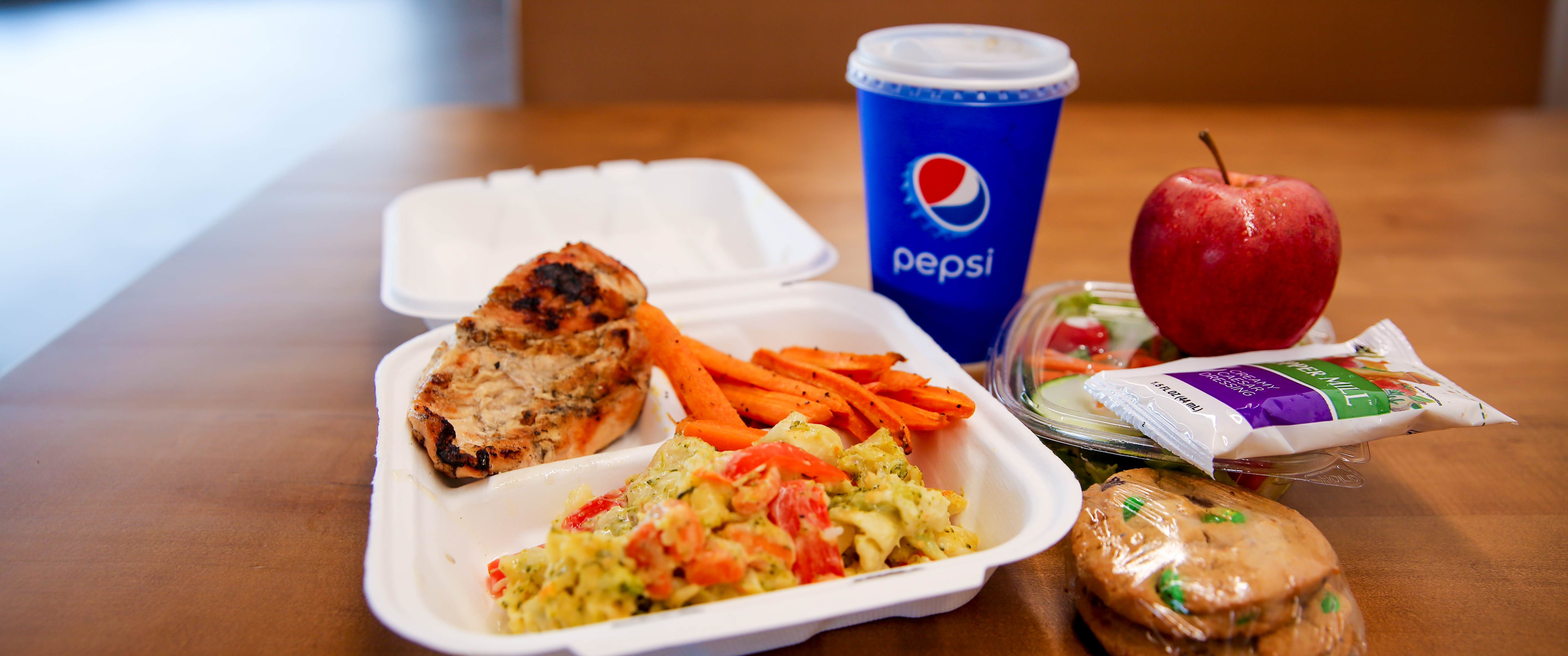 To-go meal featuring 1 entrée, 1 side, 1 drink and 1 dessert.