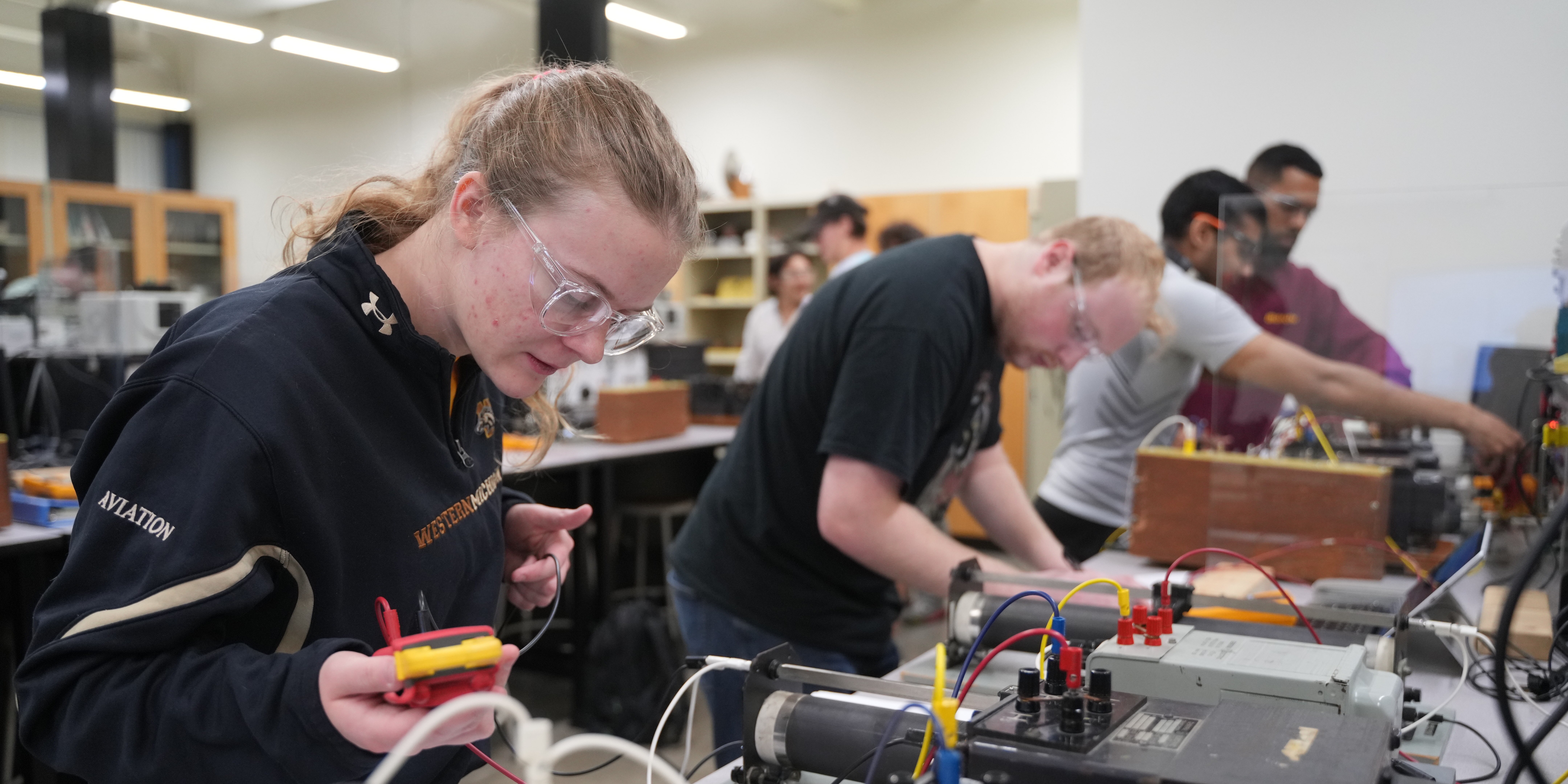 Students working with circuits and wires. 