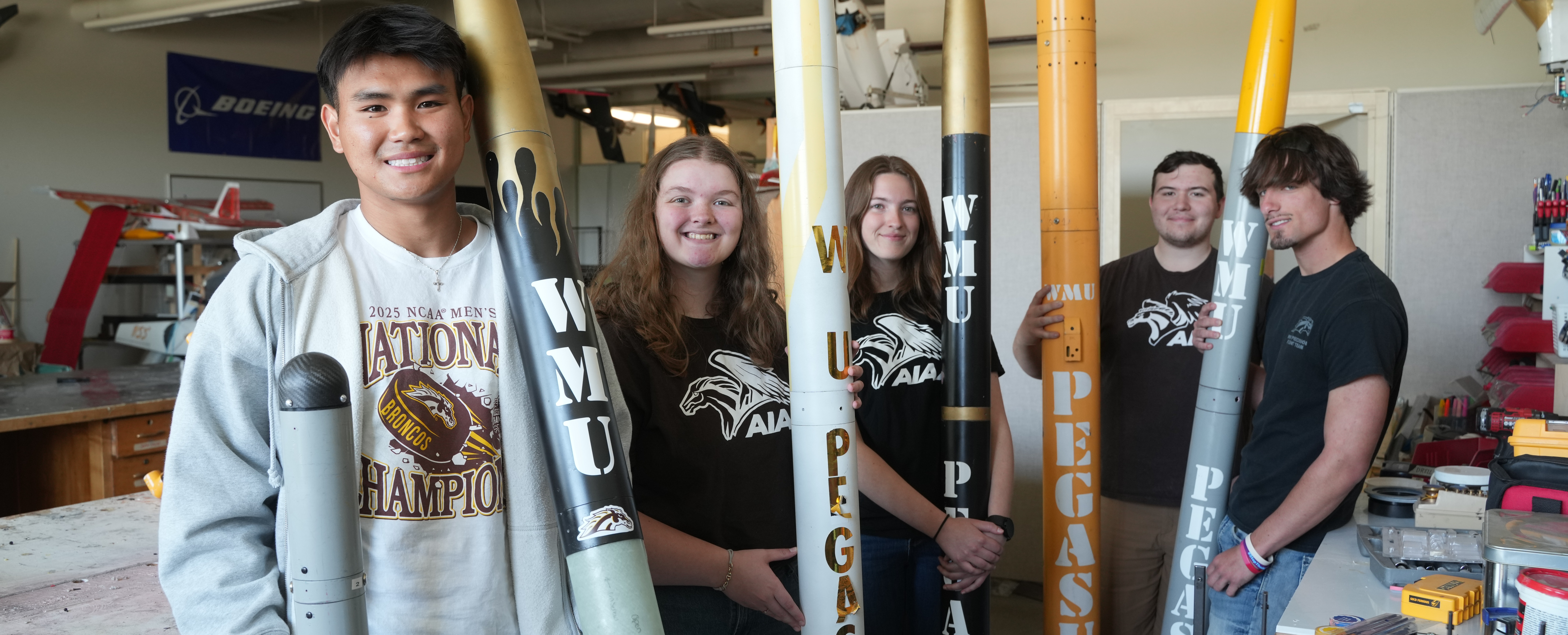 A WMU student organization posing with rockets. 