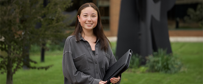A girl standing in front of the HCOB building 