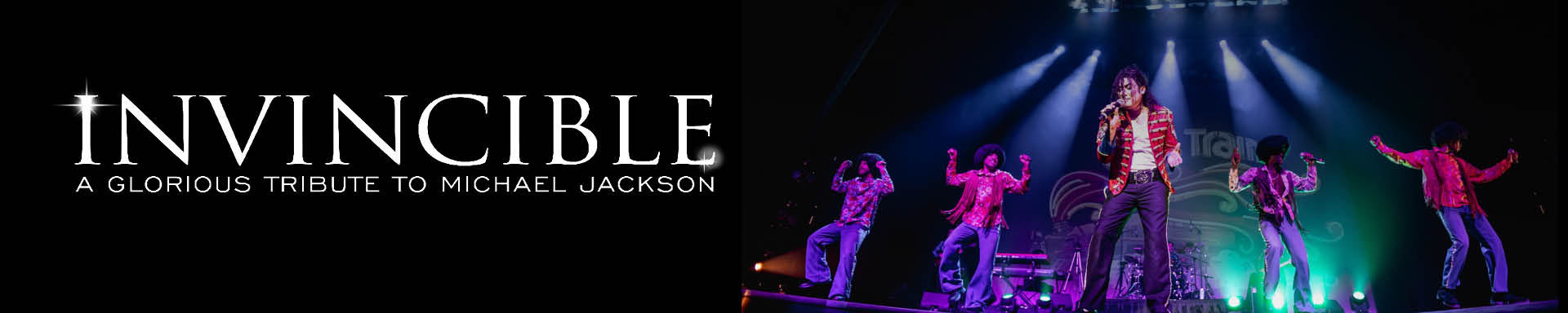 An actor playing Michael Jackson singing into a mic with Stage lights shining down and backup singer in the background.