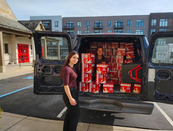 Members of ALD prepare to take a van-load of diapers to a local organization for distribution to the community.