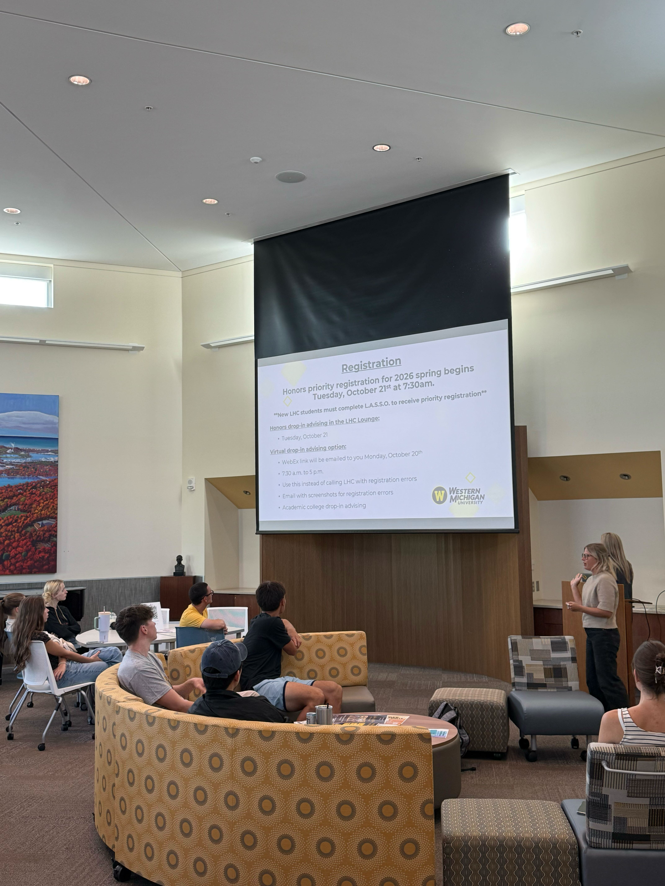 Honors advisors walk students through the registration process in the honors college lounge. 
