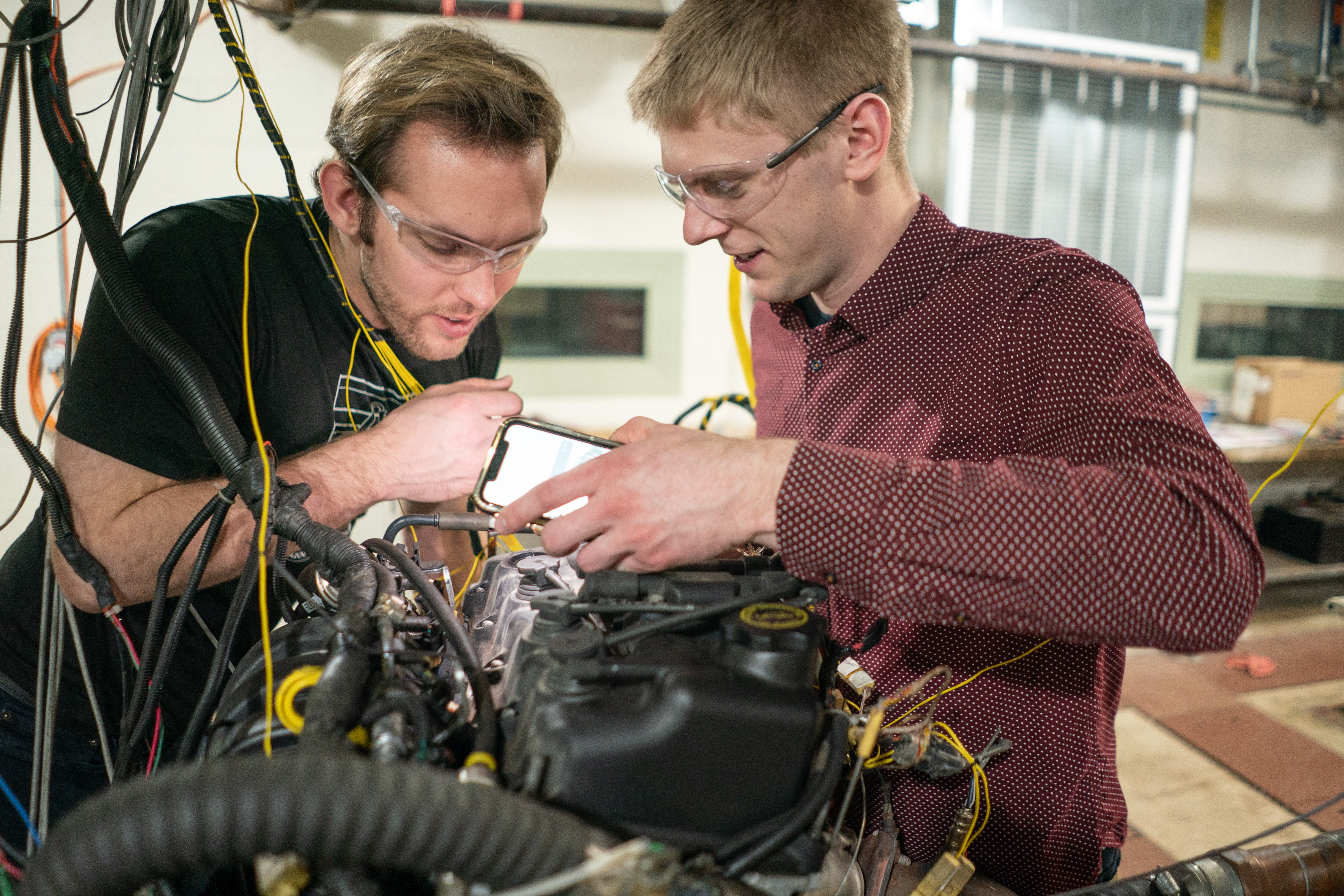 Honors students work on an automotive engine in the success lab in Floyd Hall.