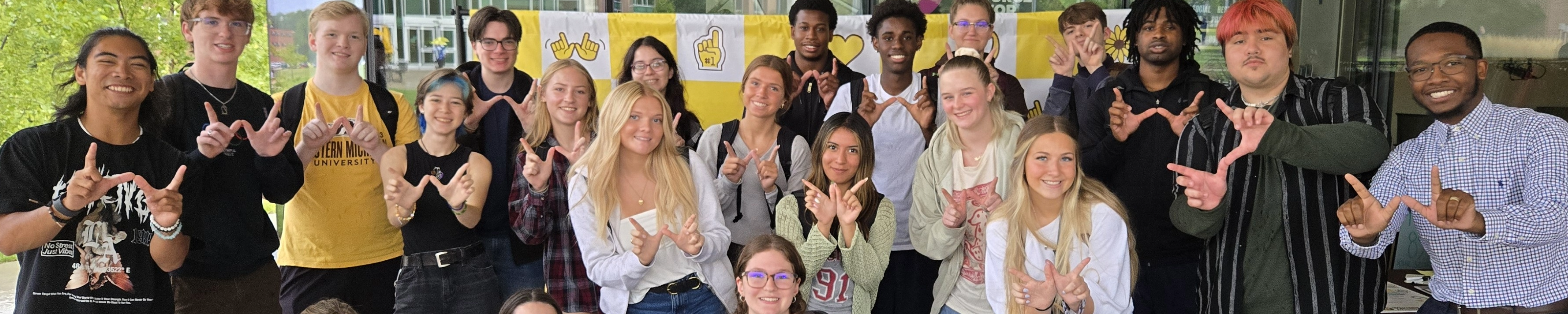 students holding up w's