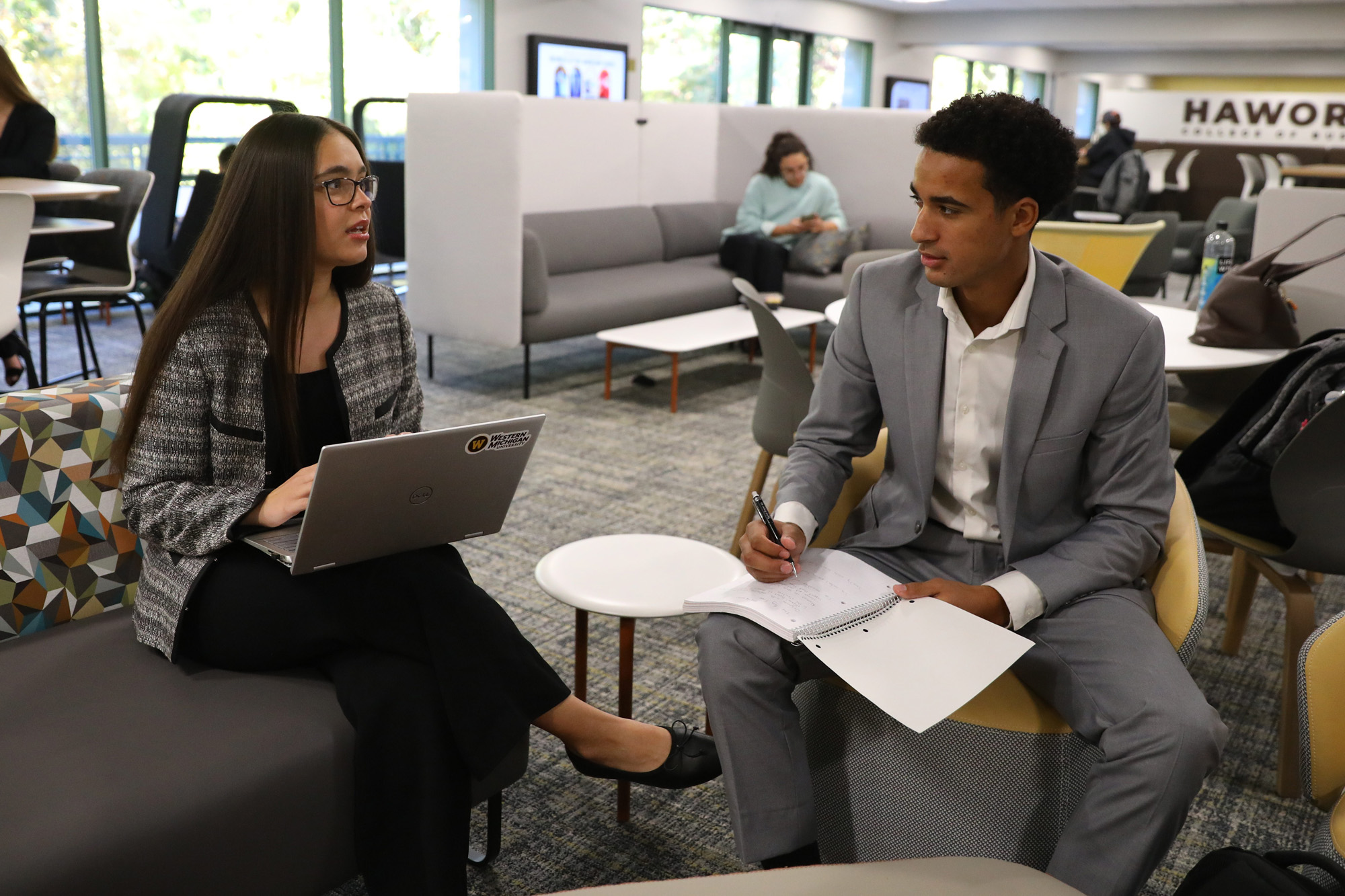 Two students seated in the Schneider Hall cafe