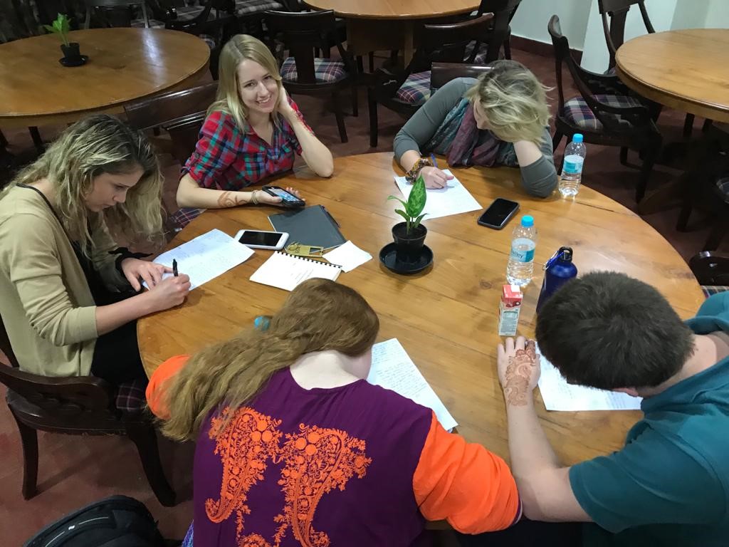 the group gathers to work on a project at a local NGO