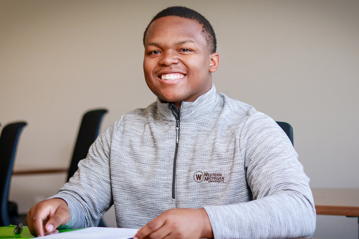 Finance student sitting in front of a notepad.