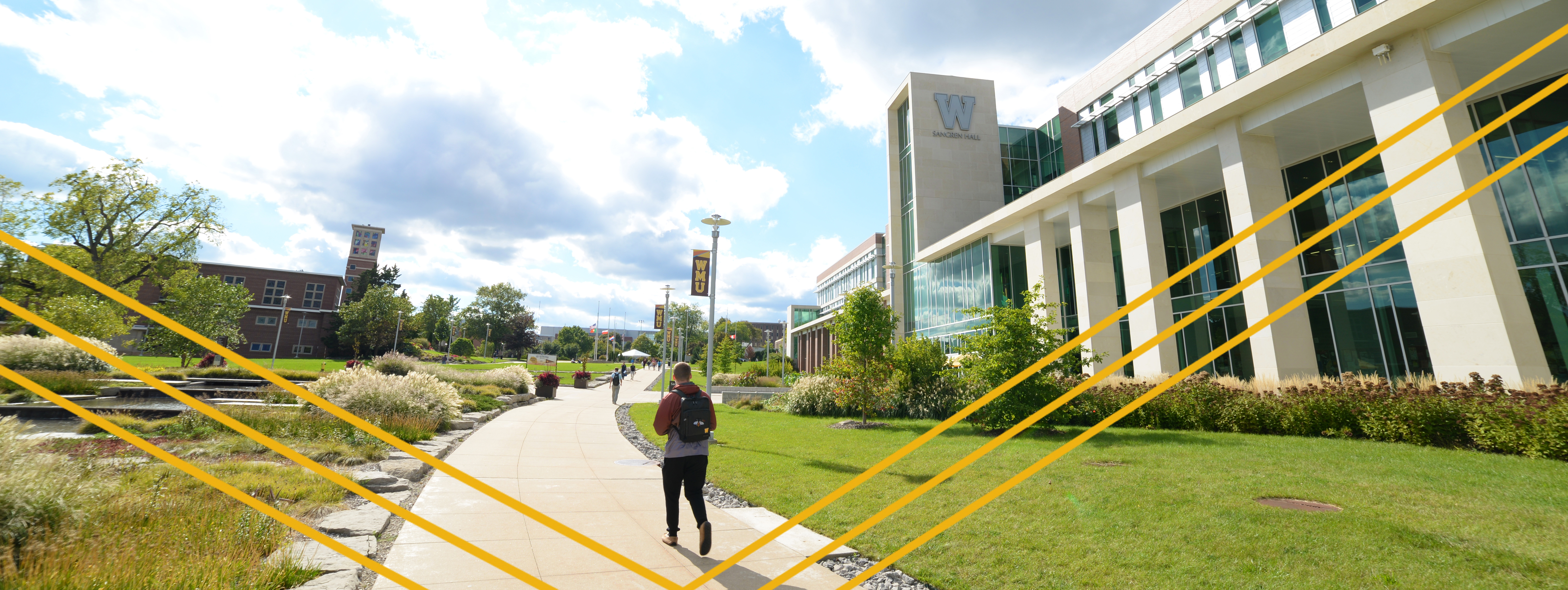 student walking outside sangren on sunny day