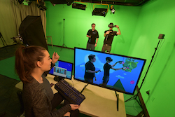 Students making a video in the green screen room.