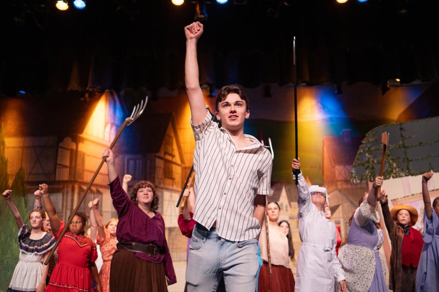 Jack Austin raises his fist into the air.