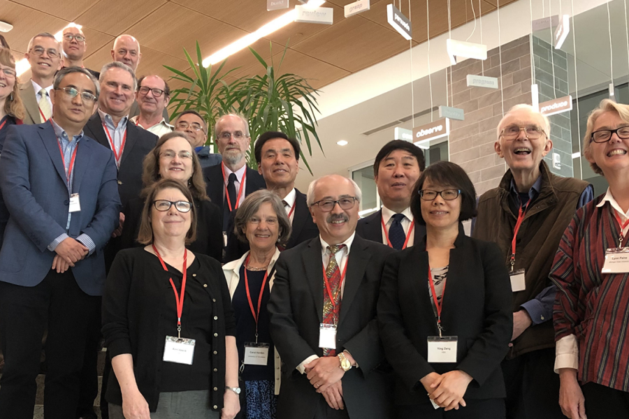 A professional group standing together on a staircase at an Asian Initiatives event.