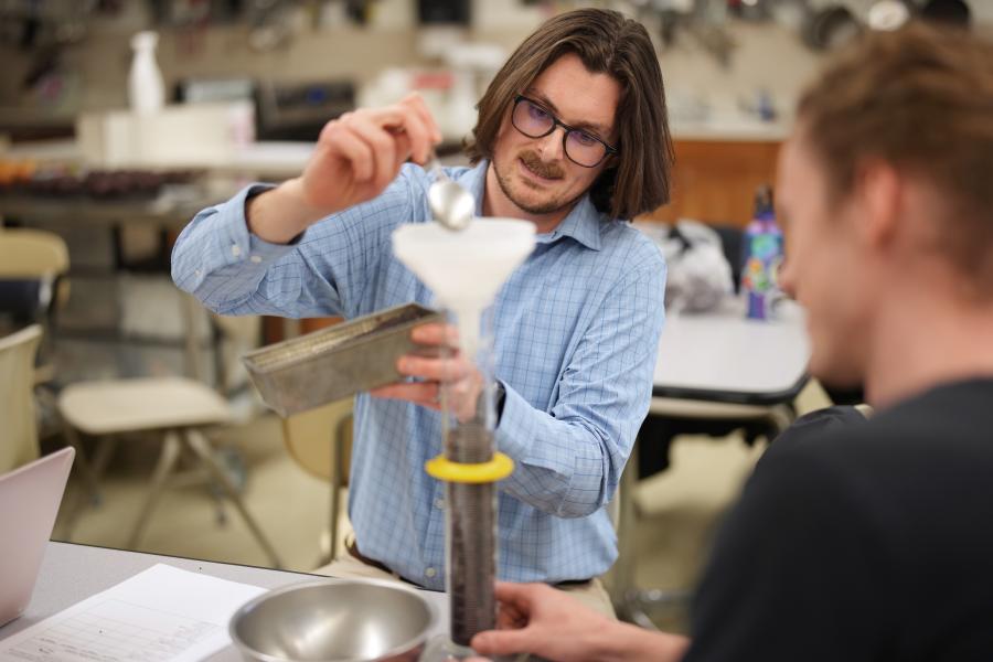 Derek Fischer measures ingredients for a recipe.