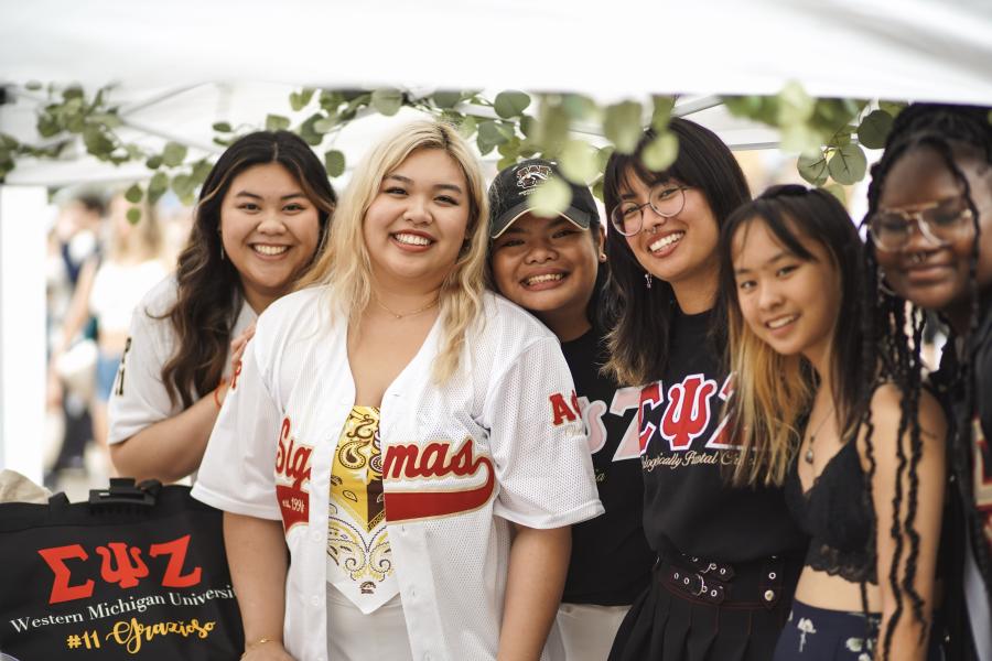 Six students smiling at the camera.