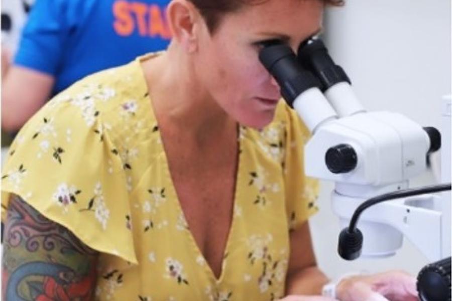 Woman using microscope in lab