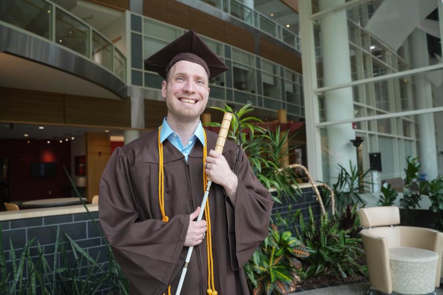 A portrait of Jeffery Crouch in his graduation cap and gown.