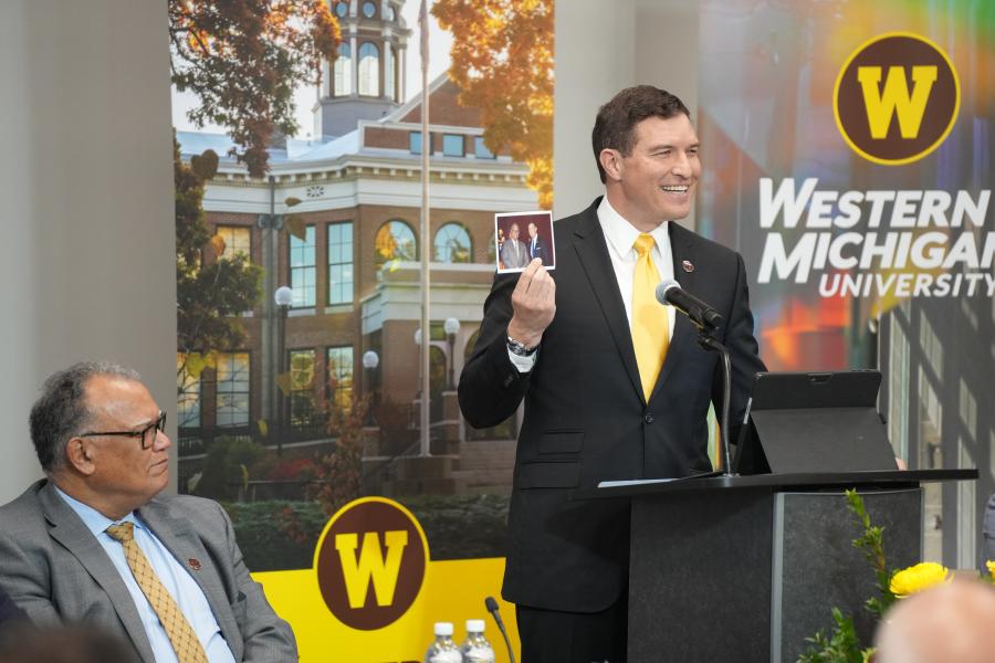 President Kavalhuna holds up a photo with President Montgomery at his Henry Ford College inauguration.