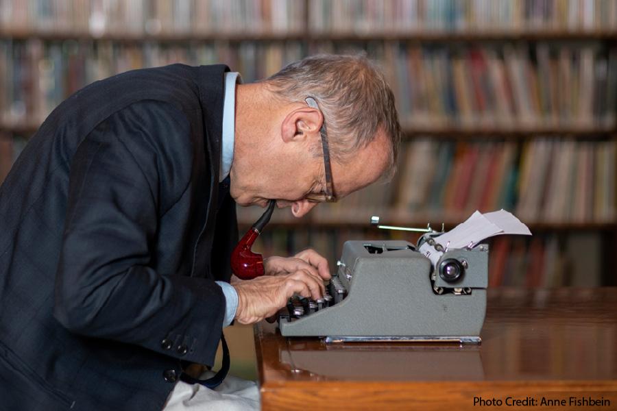 David Sedaris over a typewriter at a library