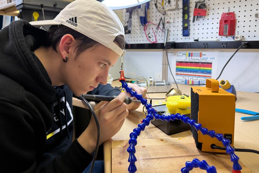 Lochlan McElroy working in lab in College of Engineering and Applied Sciences