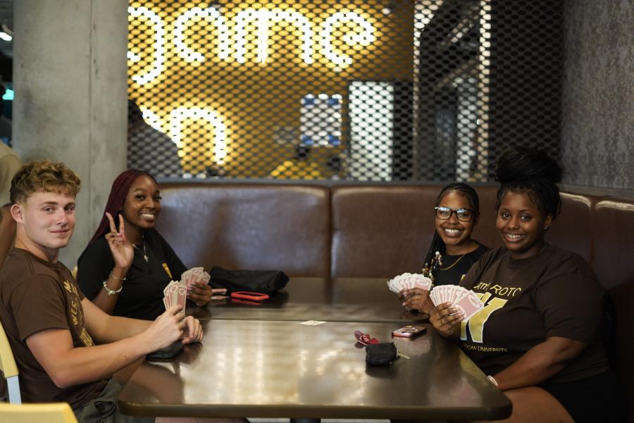Students play cards in the gaming center.